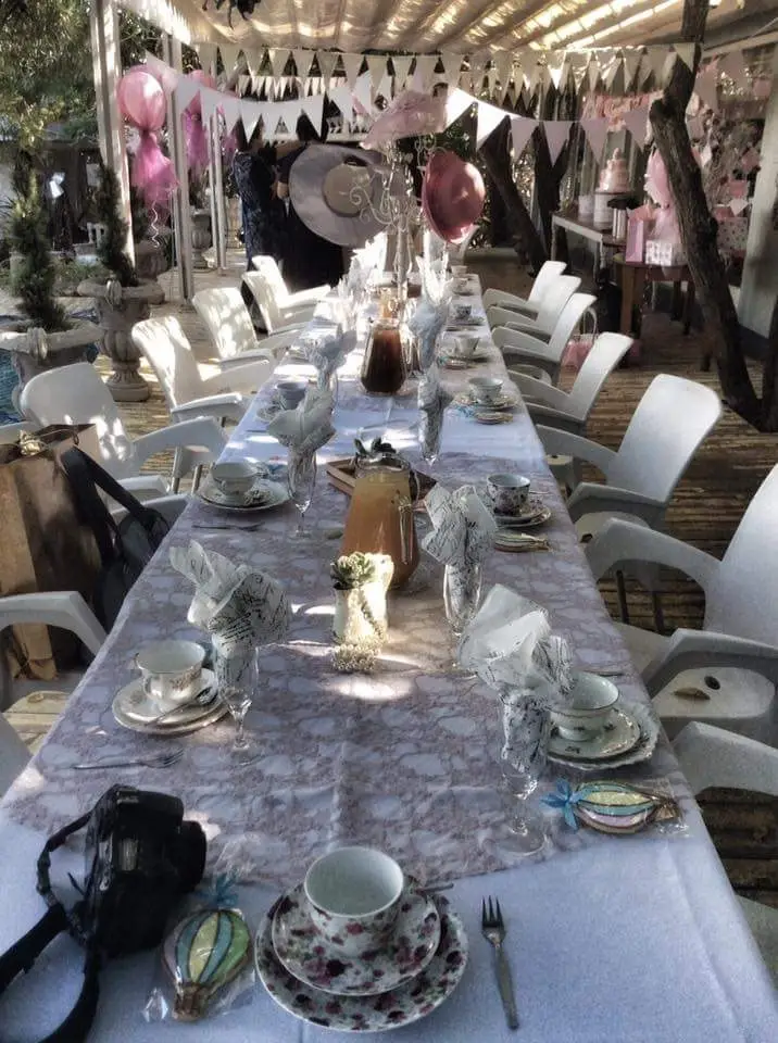 A long table set for a party in the garden room